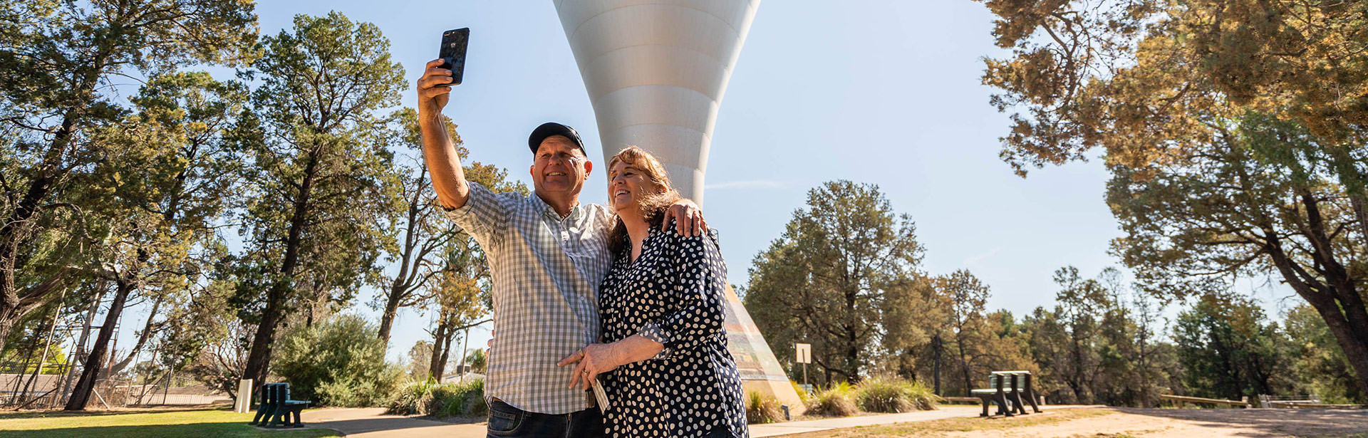 Couple infront of water tower taking selfie