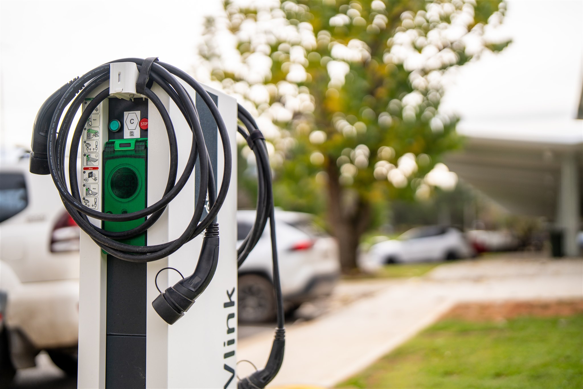 Electric vehicle charger infront of cars