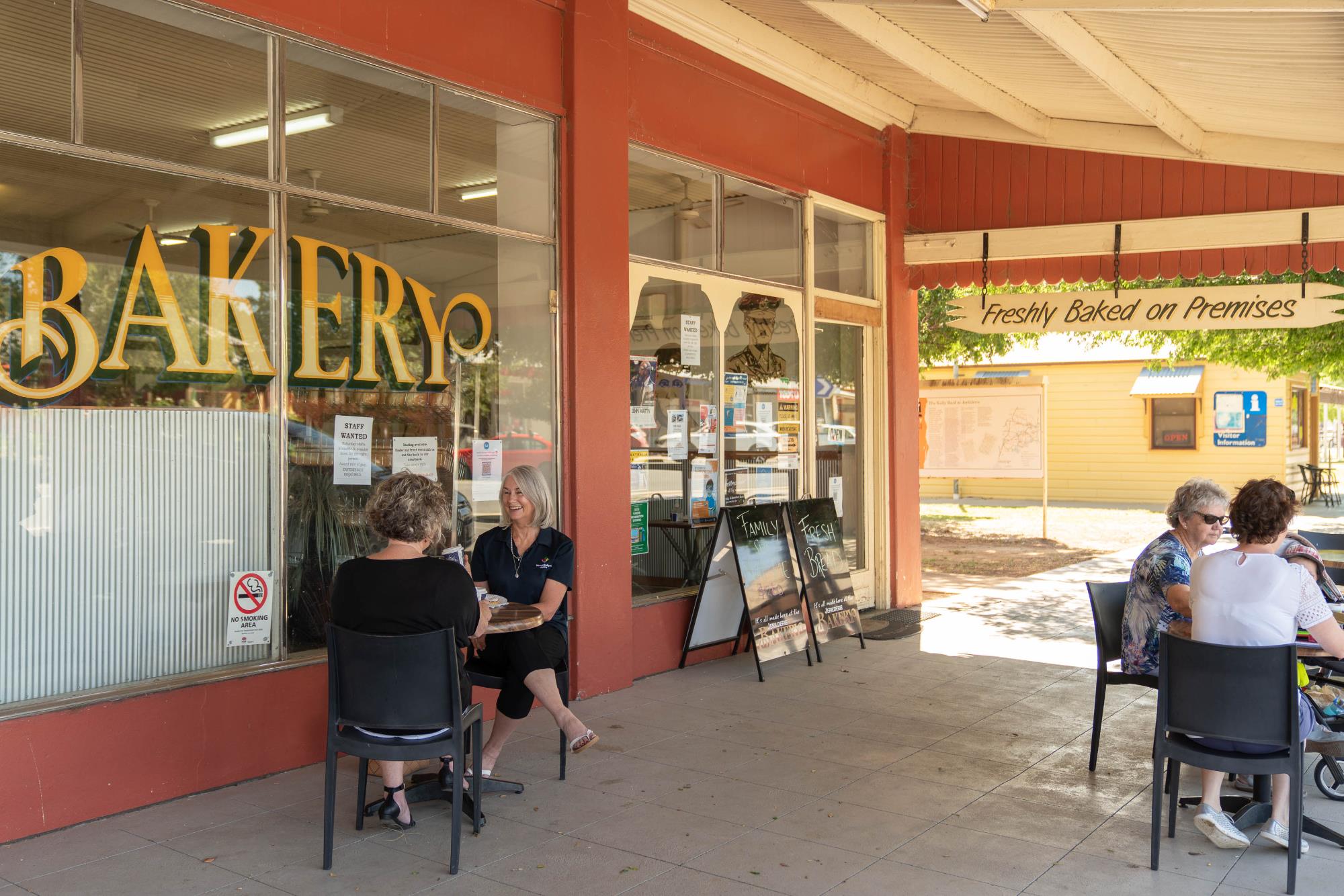 People eating outside bakery