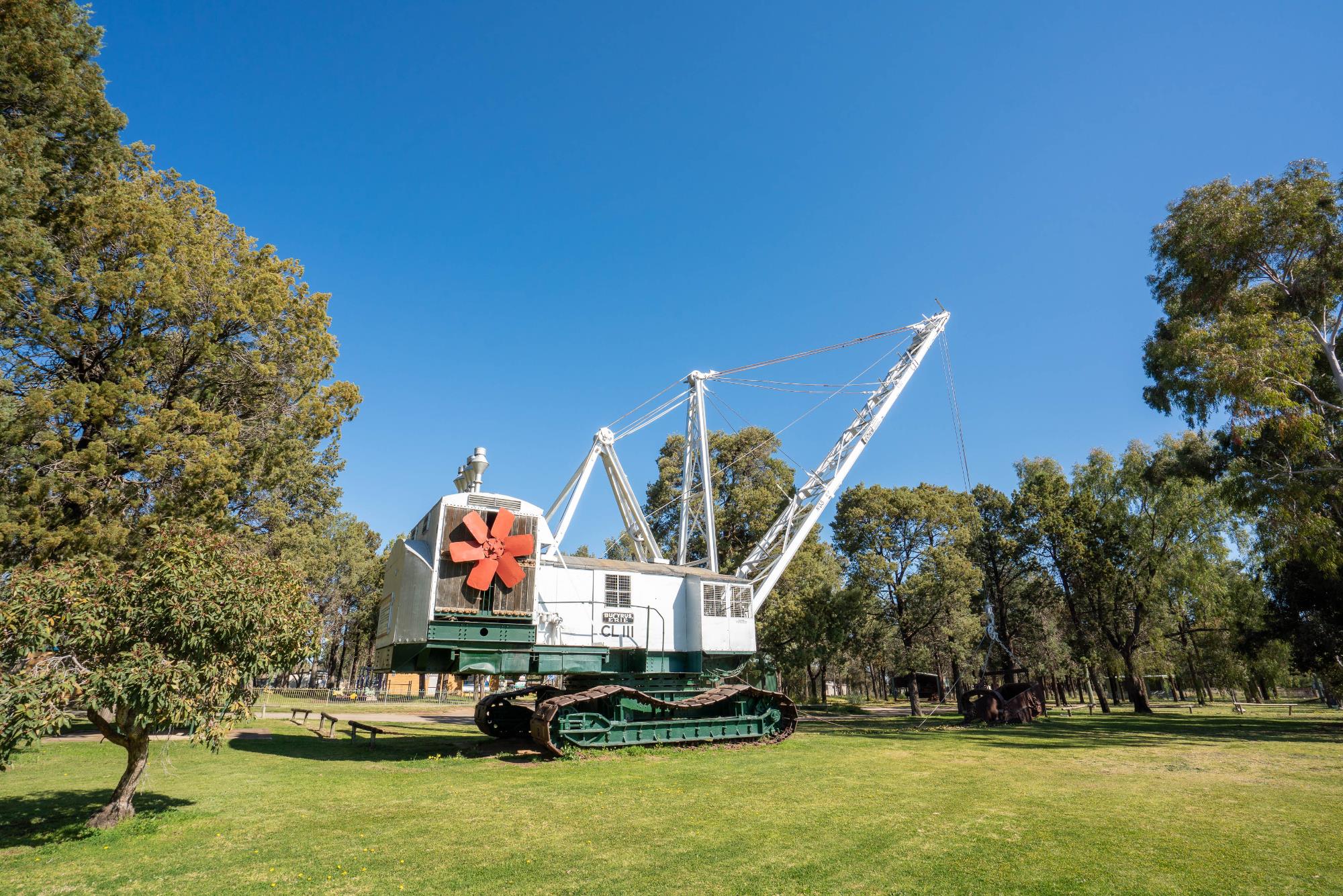 Bucyrus-Erie Dragline Excavator in park with trees behind